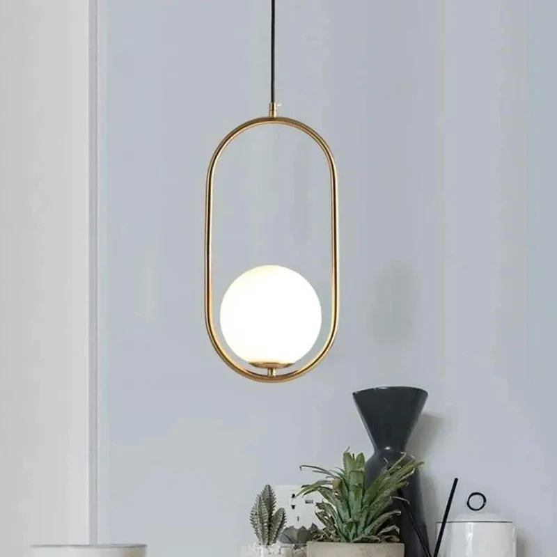 Sleek Oval Pendant Light Featuring Frosted White Glass Globe And Brushed Brass Frame Delivers Smooth Glare Free Illumination Perfect For Chic Bedroom Ambiance And Contemporary Living Room Setup Vibes