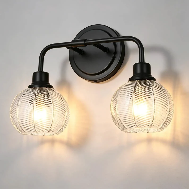 2 Light Wall Sconce Features Curved Arms And Ribbed Glass Shades With Dope Matte Black Finish Rustproof Build E26 Bulb Base Perfect For Bathrooms Kitchens Hallways Living Rooms Bringing Major Bougie Vibe To Any Space Super Sleek Look