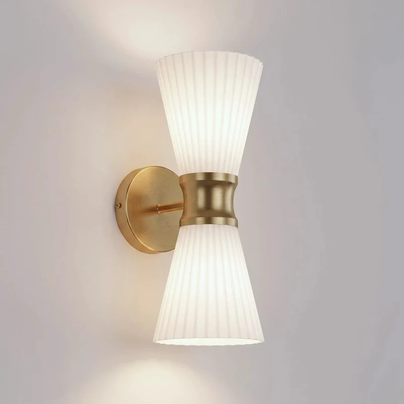 Stylish Two Light Up And Down Wall Sconce Featuring Frosted Pleated Glass Shading Wrapped In Matte Pale Brass For Effortless Vibe Setting Decor Lighting