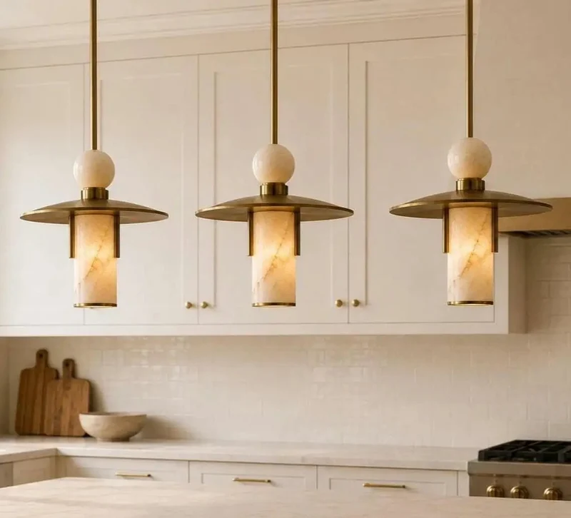 Top Shelf Modern Brass Pendant Lights Give Your Space a Serious Glow Up Featuring Alabaster Cylinder Shades and Marble Accents for Kitchen Dining Room Bar Natural Stone Ceiling Fixtures Set of 3
